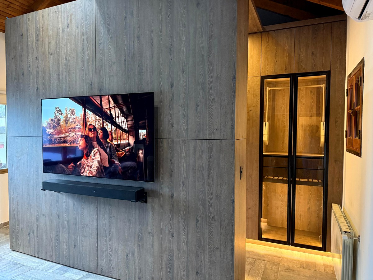 Custom timber wall panel and walk-in wardrobe by SureFit Installations Auckland